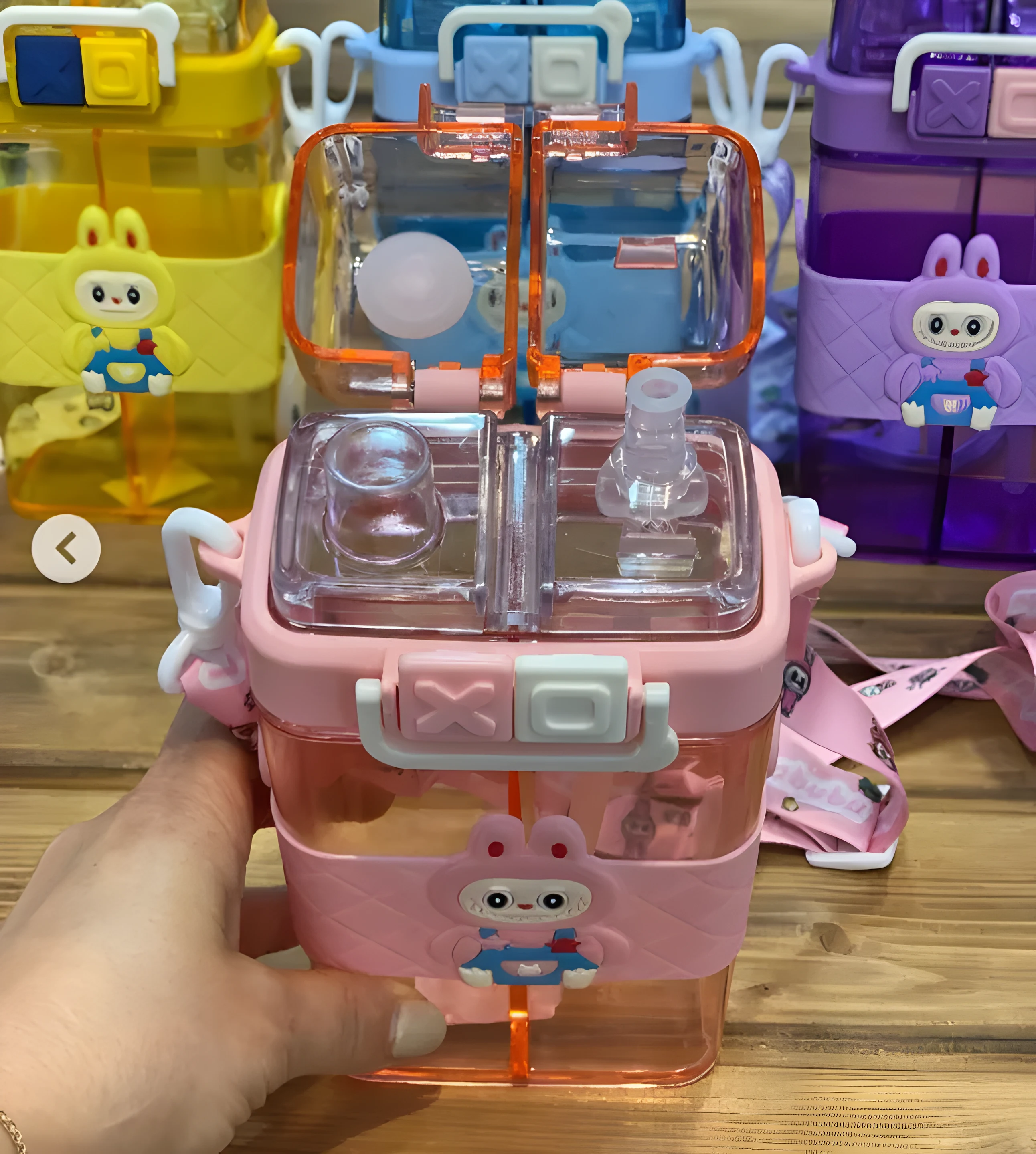 "Cute children's water bottle featuring two compartments, straw lid, bunny character, and carrying strap."