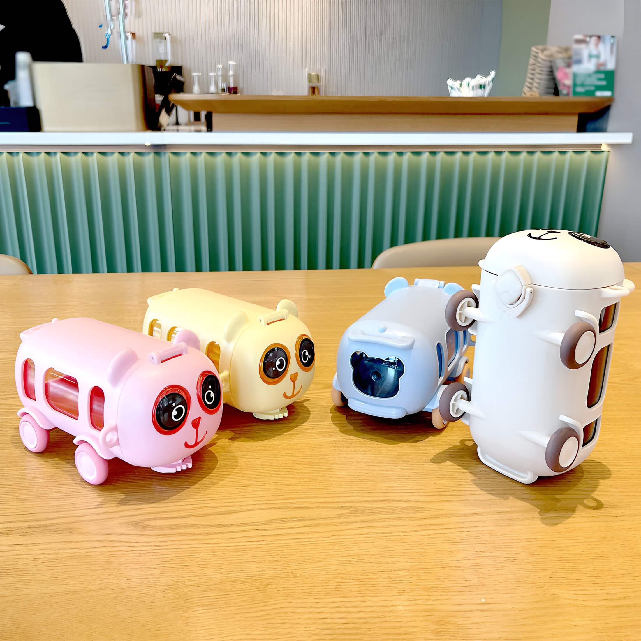Panda Bus Water Bottle and Sipper in blue, pink, white, and yellow colors displayed together – cute, colorful, and perfect for kids daily hydration